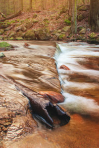 Beautiful mountain waterfalls with long exposure in golden spring sunlight. Ilsefälle of the mountain river Ilse in the Ilsetal in Ilsenburg, National Park Harz, Saxony-Anhalt in Germany Beautiful mountain waterfalls with long exposure in golden spring sunlight. Ilsefälle of the mountain river Ilse in the Ilsetal in Ilsenburg, National Park Harz, Saxony-Anhalt in Germany